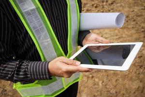 construction engineer worker using tablet computer at building site photo