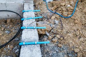 Pest control pipe system install at new house construction foundation for termite protection photo