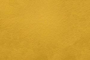 Yellow color cement wall texture photo