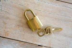 Golden padlock on wood background photo