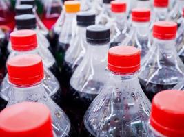 Carbonated soft drink bottles close up photo