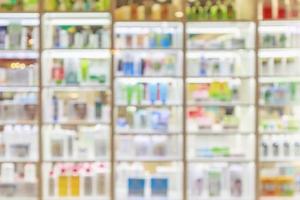 medicines healthcare product and cosmetics arranged on shelves in the pharmacy blurred defocused background photo