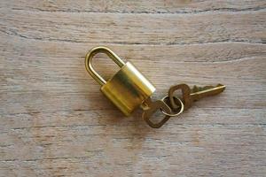 Golden padlock on wood background photo