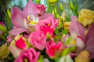 Bouquet with orchids and roses on a beautiful background closeup photo