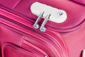 combination lock on red suitcase travel bag photo