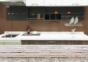 Empty wooden table and blurred kitchen background photo