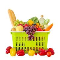 Fresh fruits and vegetables grocery product in green shopping basket isolated on white background photo