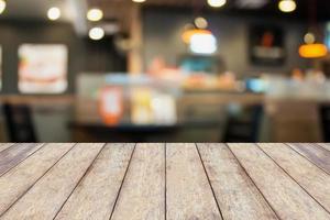 Empty wood table with cafe restaurant blur background with bokeh photo