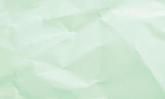 mint green colored crumpled paper texture background for design, decorative. photo