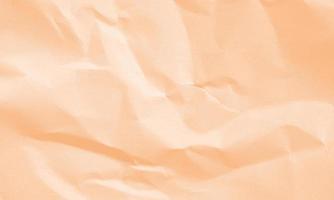 peach colored crumpled paper texture background for design, decorative. photo