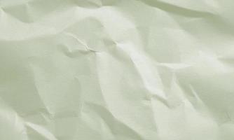 avocado green colored crumpled paper texture background for design, decorative. photo