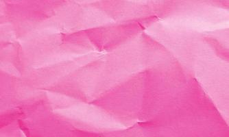 magenta colored crumpled paper texture background for design, decorative. photo