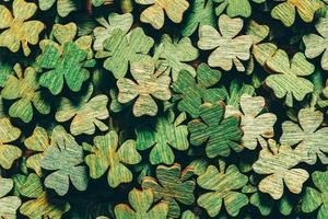 Pile of wooden green four-leaf clovers photo