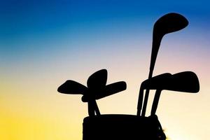 Golf equipment silhouett, clubs at sunset photo