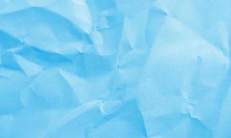 cyan colored crumpled paper texture background for design, decorative. photo