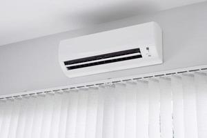 Air conditioner on white wall background photo