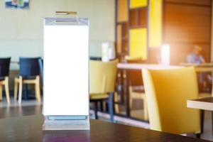 Mock up Blank white menu frame on cafe restaurant table photo