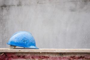 Blue hard hat on house building construction site photo