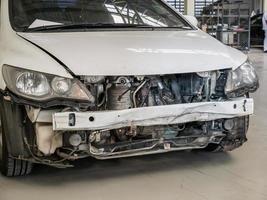 damaged car waiting for repair in the car repair garage photo