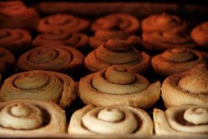 Cinnamon rolls are baked in oven, homemade cakes. photo