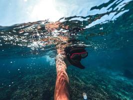 Snorkeling in the sea on a tropical island photo