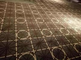 dark brown carpet with circle and square motif in the room photo