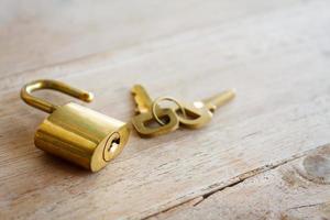 Golden padlock on wood background photo