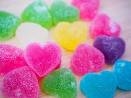 colorful hearts candy on wood for valentines background photo