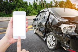 Driver using mobile smartphone with car crash accident on the road photo