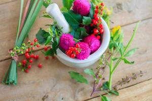 Fresh herbs in the mortar, alternative medicine photo