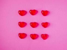 red valentine candy hearts shape on pink background photo