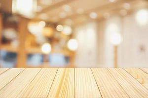 wood table with abstract blurred cafe restaurant with bokeh lights defocused background photo