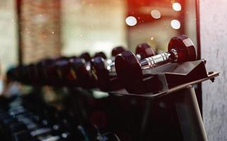 dumbbell weight lifting equipment Exercise equipment in the gym, arranged in an orderly line. in the gym photo