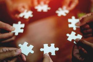 teamwork white business and puzzle of cooperation unity concept jigsaw puzzle close-up hand of hand connected jigsaw puzzle connected to each other business solution Success Concepts and Strategies photo