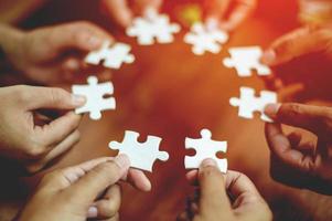 teamwork white business and puzzle of cooperation unity concept jigsaw puzzle close-up hand of hand connected jigsaw puzzle connected to each other business solution Success Concepts and Strategies photo