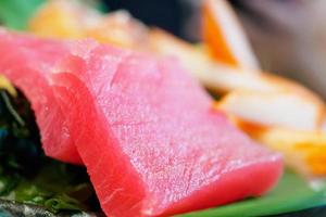 Sashimi set on ice with salmon tuna with chopsticks photo