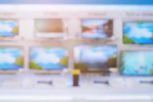 Television shelves retail shop display in Electronic Department store blurred background photo