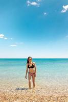 The girl is sunbathing on the beach photo