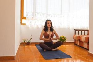 Woman doing yoga at home photo