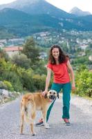 A woman walks shepherd dog photo