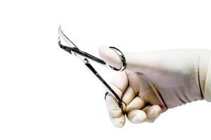 Doctor's hand  in the medical latex glove holding Medical umbilical cord scissor and shows the gesture of holding the scissors isolate on white background and make with path. photo