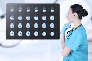 Doctor radiologist looks at the MRI, ultrasound, the child's brain in the CT scan room. Soft blurred background. Medical poster. photo