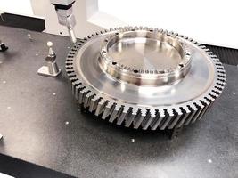 Large shiny spare part, engine, turbine, gear, stainless steel part. photo