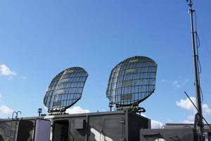 Radiolocating war machine. A target acquisition and distribution radar system. Radar of military machine under open sky. photo