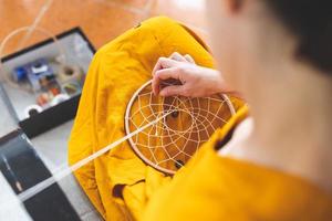 Woman making a dream catcher from threads photo