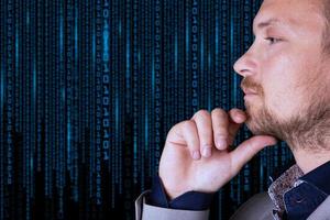 Binary code. A businessman looks at a background of digital binary code numbers. Copy space. photo