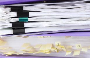 Stack of reporting paper documents in a purple folder with bookmarks, business documents for annual reports. Business analytics. Business office concept, soft focus. photo
