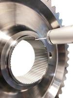 Large shiny engine part, turbine with bearing, gear, stainless steel part. Vertical format. photo