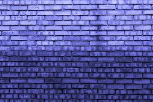 Brick wall background painted in trendy Very Peri purple. copy space. photo