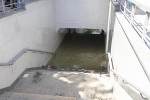 Flooded pedestrian crossing under the highway in the city. Consequences after the flood, natural disaster. photo